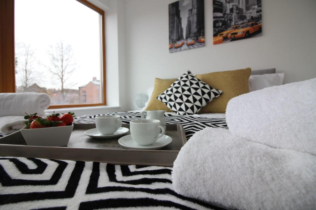 a living room with a coffee table and a couch at Britannia Chambers in Leek