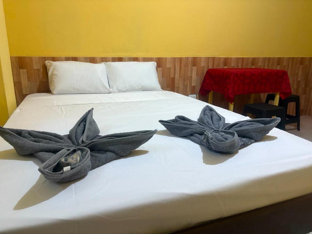 a bed with two flowers on top of it at Welcome to the Amazon in Iquitos