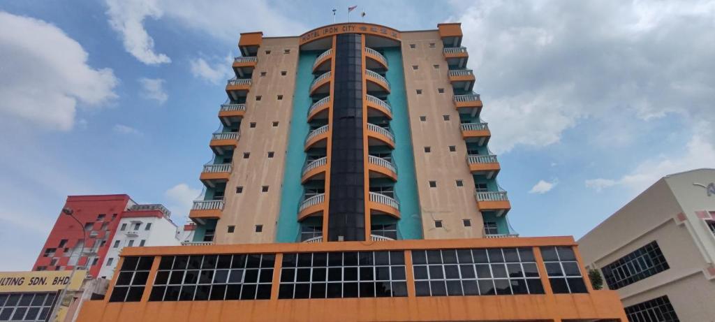 a tall apartment building with a blue at Hotel Ipoh City in Ipoh