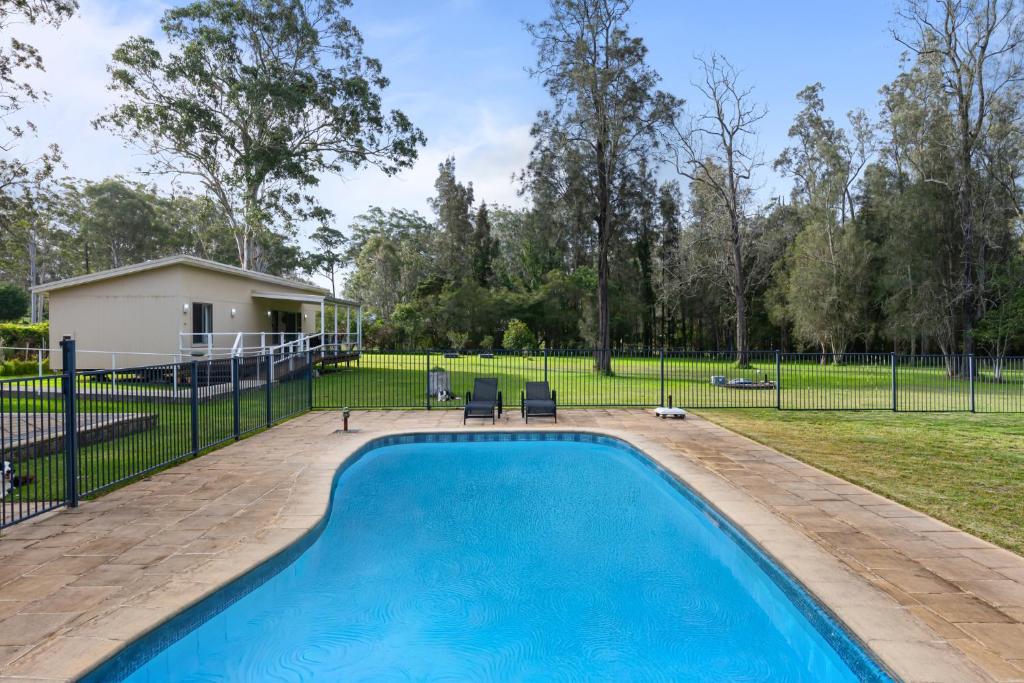 a swimming pool in a yard with a house at Native Retreat - Tranquil Seaham Escape in Seaham