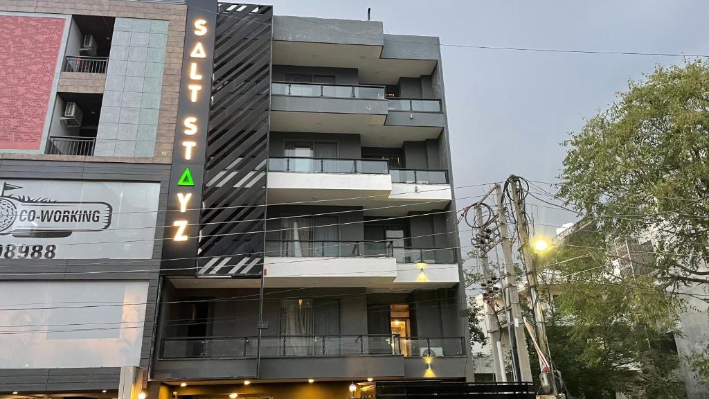 a tall building with a sign on the side of it at Saltstayz Express - Golf Course Road & DLF Phase-1 in Gurgaon