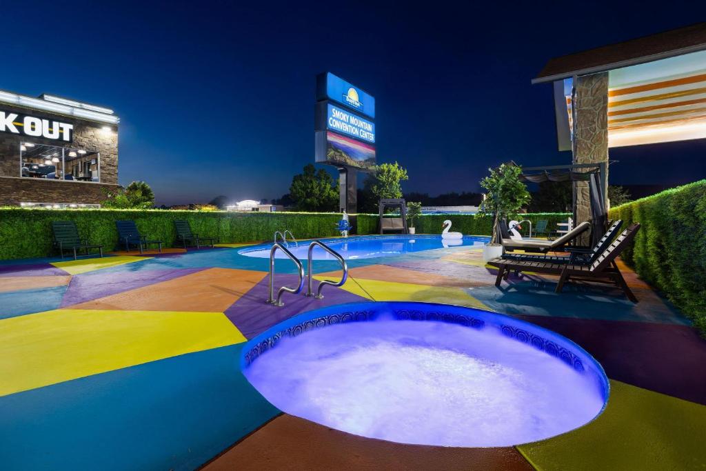 a jacuzzi tub in a swimming pool at night at Days Inn By Wyndham Pigeon Forge South in Pigeon Forge