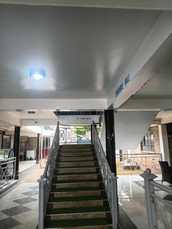 a staircase leading up to a building with a blue light at The Sychar Palace Hotel in Kanga