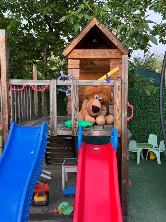 a stuffed teddy bear sitting in a play house at Casa Nita in Corbu