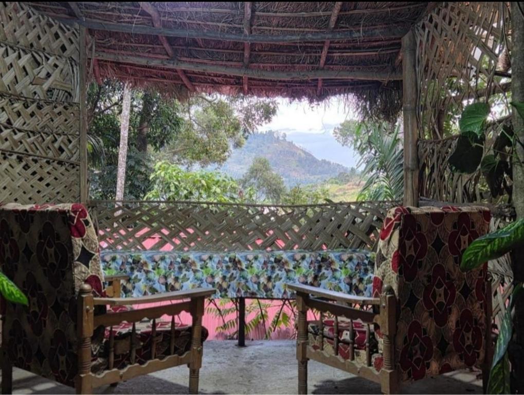 a screened in porch with two chairs and a window at Misty Mount Resort in Ella