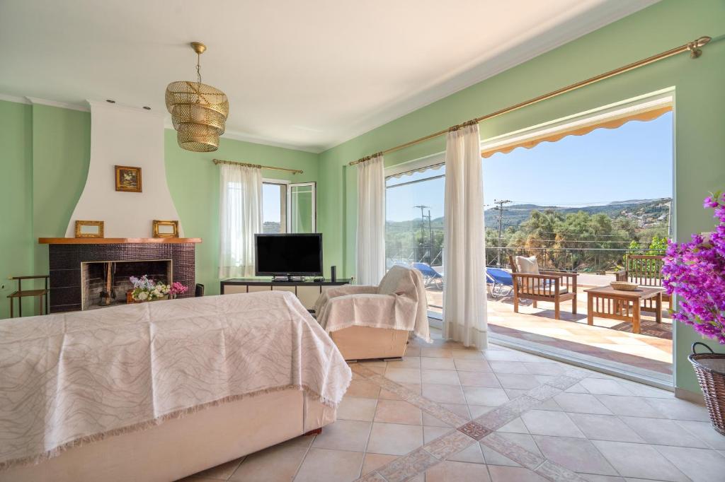 a bedroom with a bed and a view of a patio at Agis Luxury House in Lefkada
