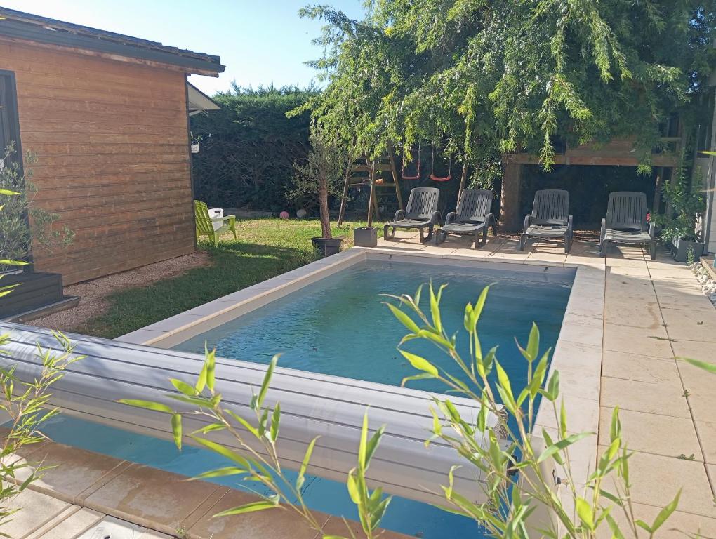 a swimming pool in the backyard of a house at Chambres cosy proche cnpe Bugey - via rhona avec piscine in Chavanoz