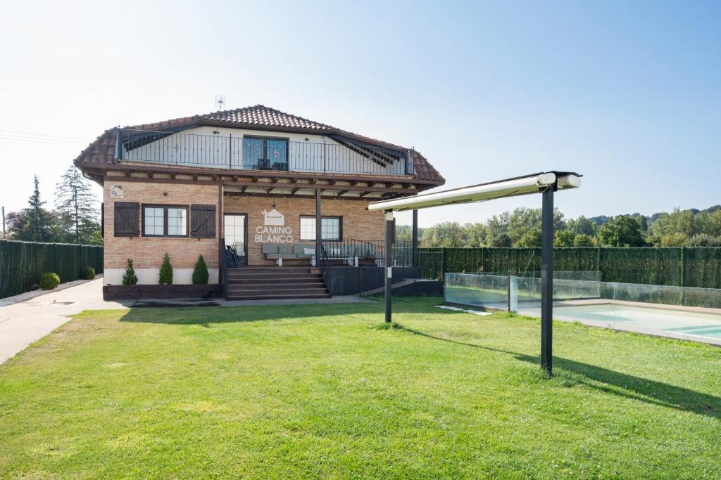 a house with a tennis court in front of it at Camino Blanco in Ibeas de Juarros