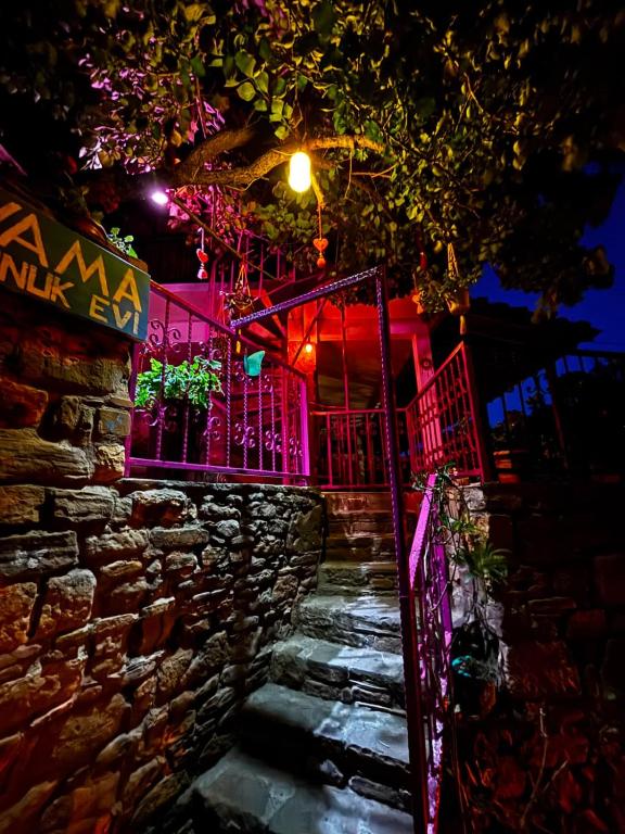 a stone staircase leading up to a building with pink lights at Vama Konuk Evi in Gokceada Town