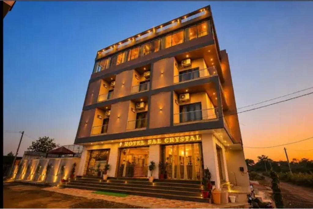 a large white building with windows and stairs at FabHotel The Crystal in Udaipur