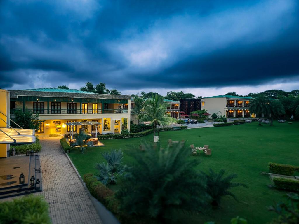 a building with a large yard in front of it at The creek boutique resort & spa in Bolpur