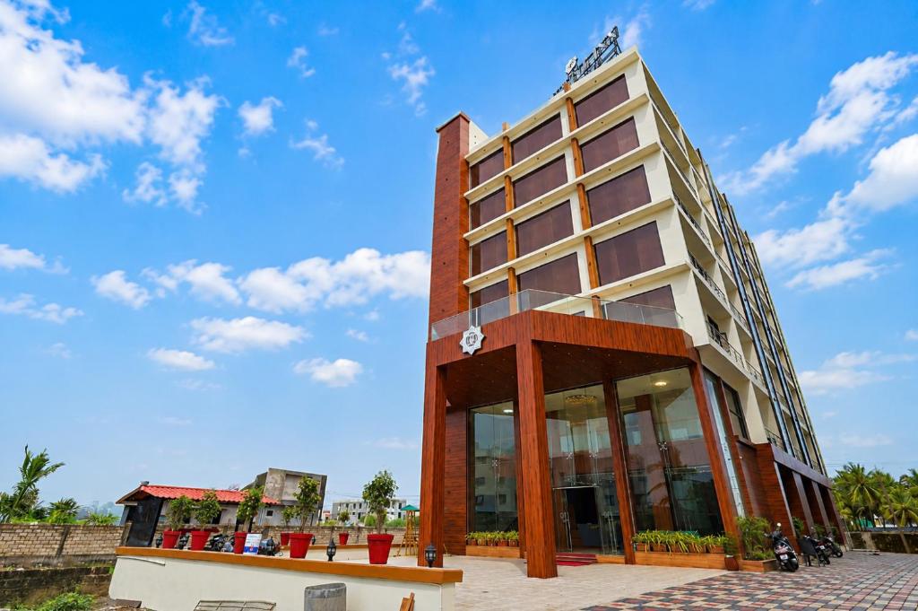 a building with a blue sky in the background at Hotel Sunshine Inn, Somnath in Somnath