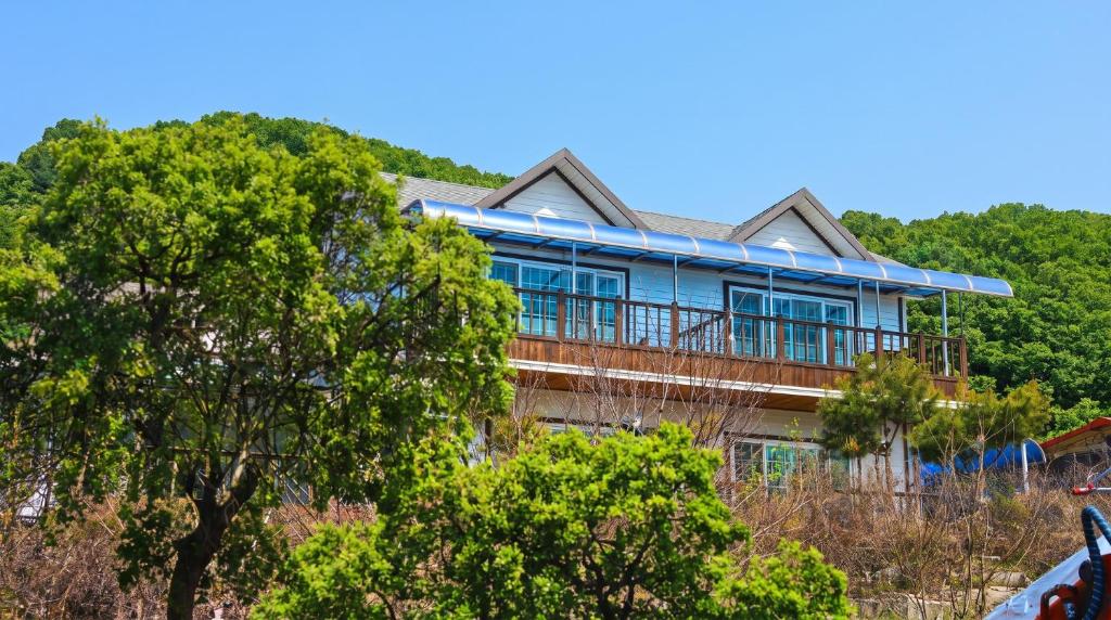 a house on top of a hill with trees at Hwacheon Turkey Valley in Hwach'ŏn
