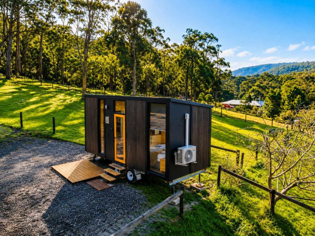 a tiny house sitting on top of a field at Gum Tree by Tiny Away in Dixons Creek