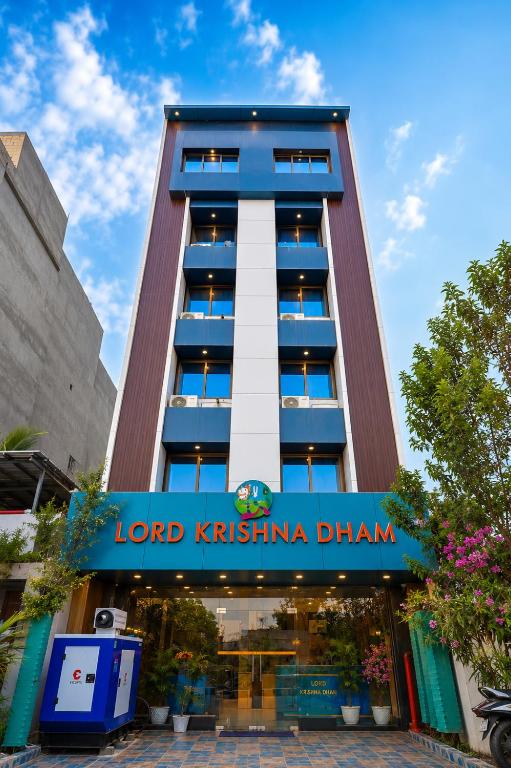 a tall building with a sign in front of it at Hotel Lord Krishna Dham in Dwarka