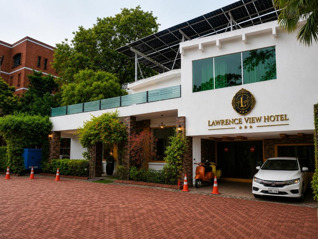 a car parked in front of a building at Lawrence View Hotel, Lahore in Lahore