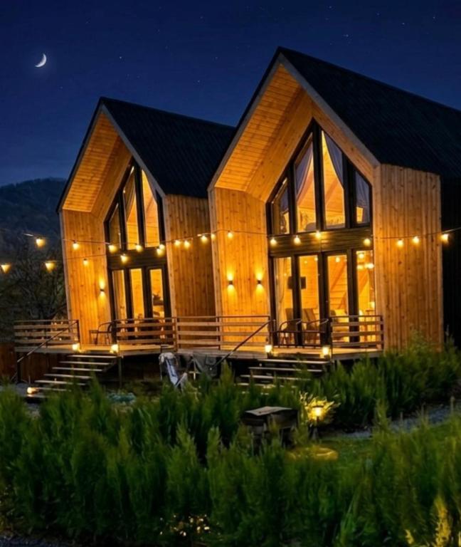 a wooden house with lights on it at night at Weekend Borjomi in Borjomi
