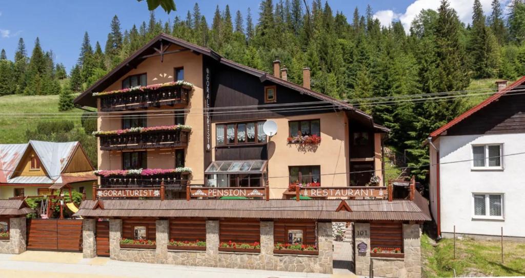 a large house with balconies and flowers on it at Goralturist in Ždiar
