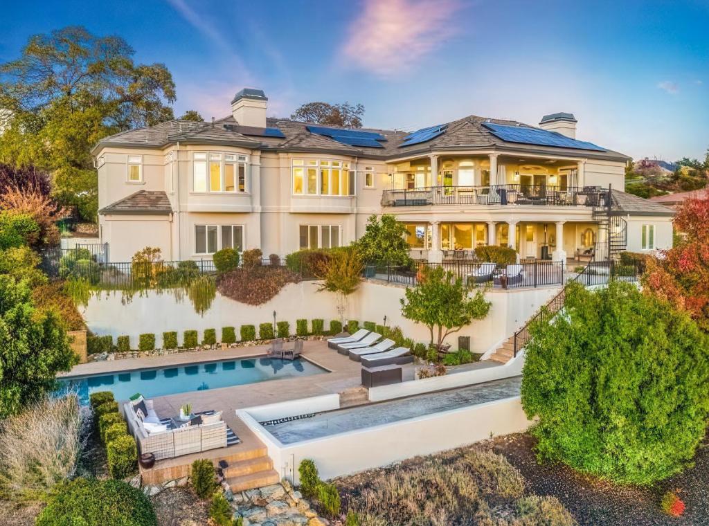 an aerial view of a mansion with a swimming pool at Serrano Village Villa in El Dorado Hills