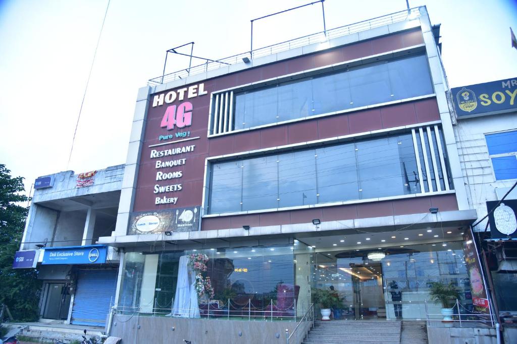 a store front of a building with a clock on it at Hotel 4G in Bhopal