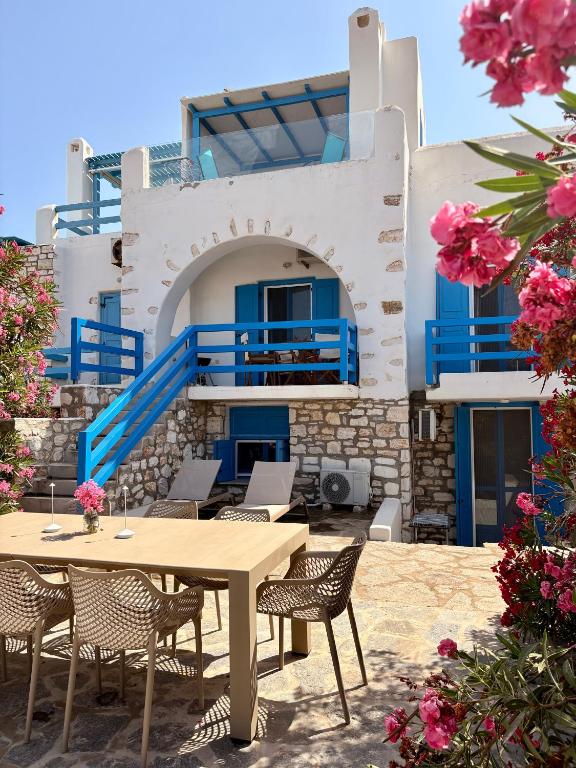 a table and chairs in front of a building at Paros Home in Kampos Paros