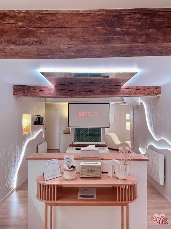 a reception desk with a sign that reads netflix at Les Jolies Nuits - À la folie, Loft & Spa in Montrevault
