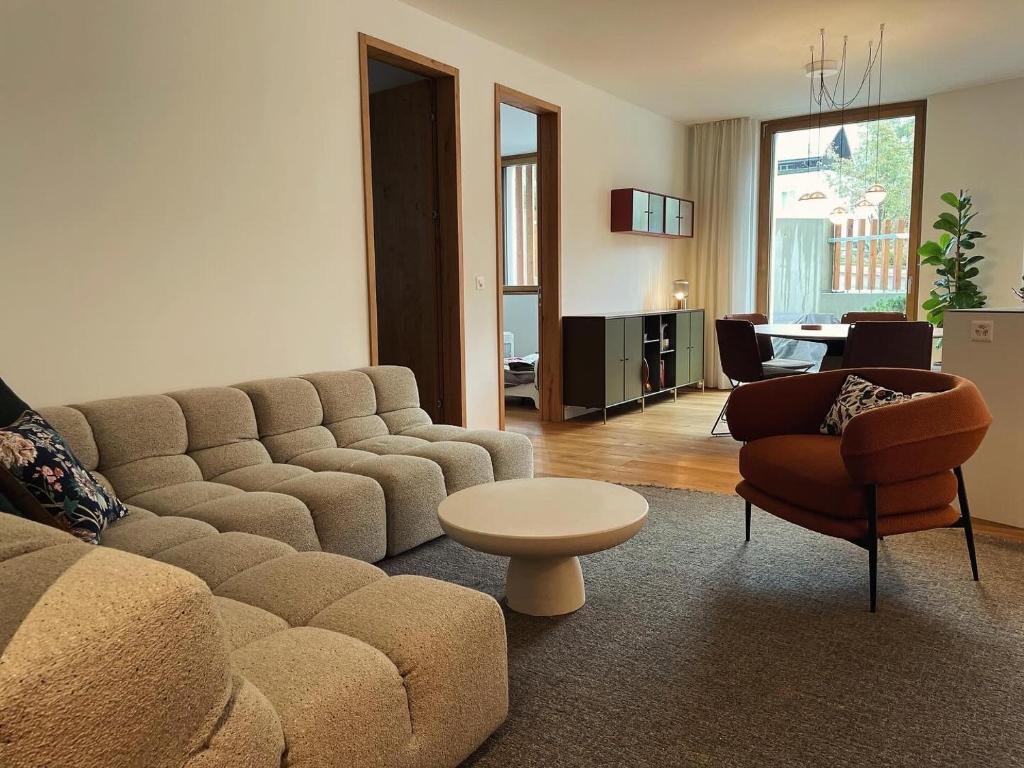 a living room with a couch and a table and chairs at Casa Rok in Flims