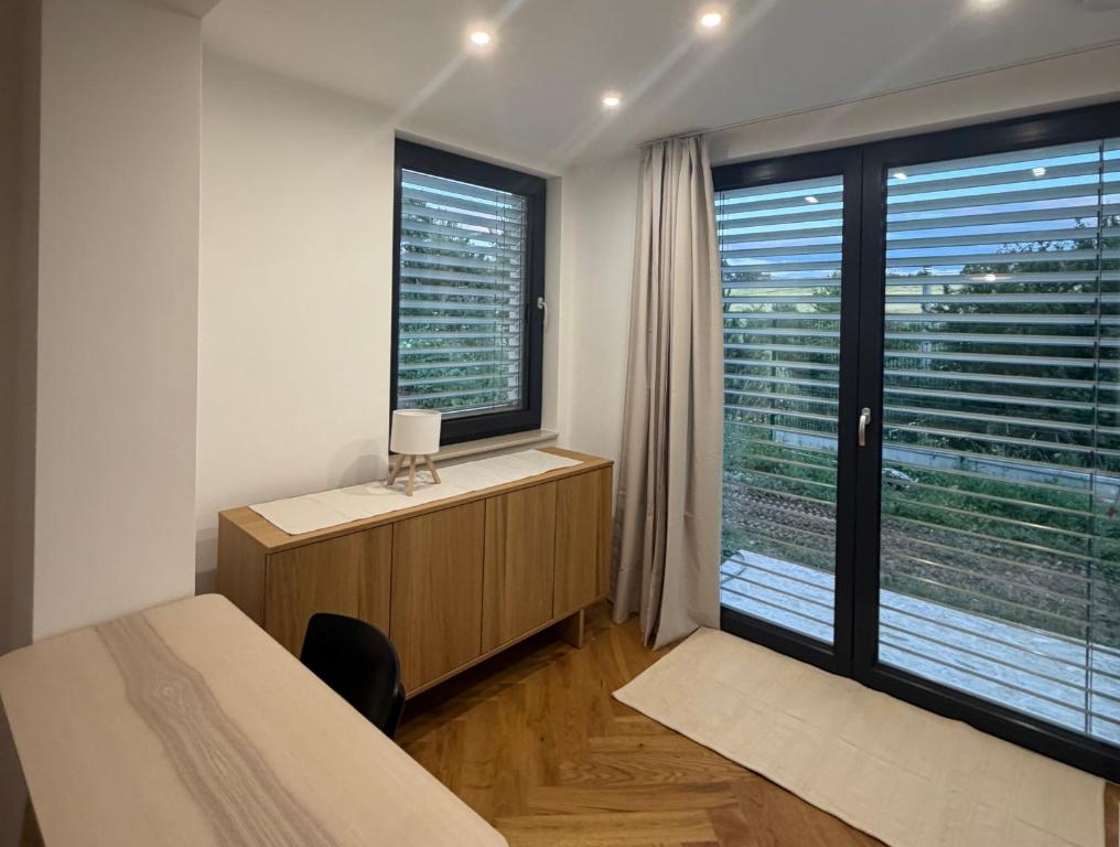 a bedroom with a bed and a large window at Studio E9 in Žilina