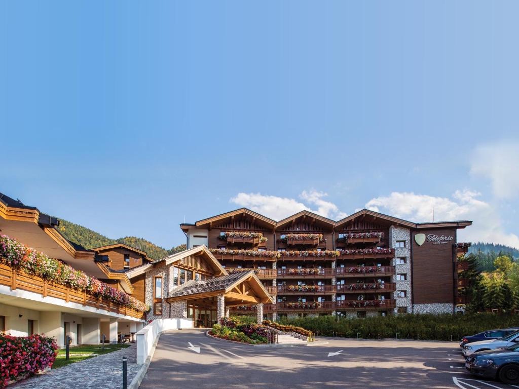 a hotel with a parking lot in front of it at Teleferic Grand Hotel in Poiana Brasov