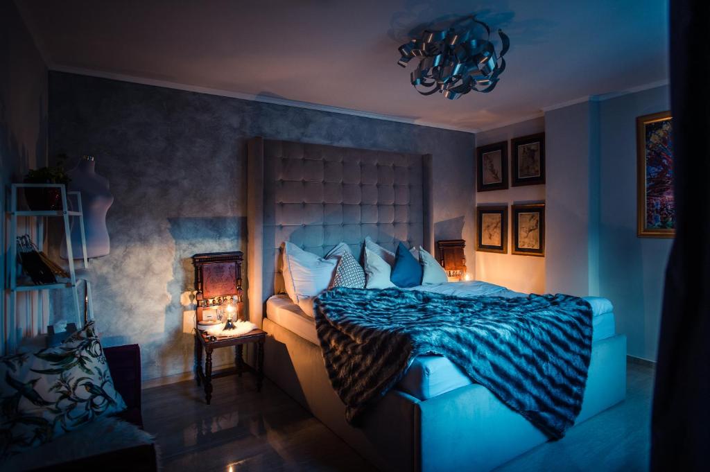 a blue bedroom with a bed with a blue comforter at Luxury Apartments No. 91 in Český Krumlov