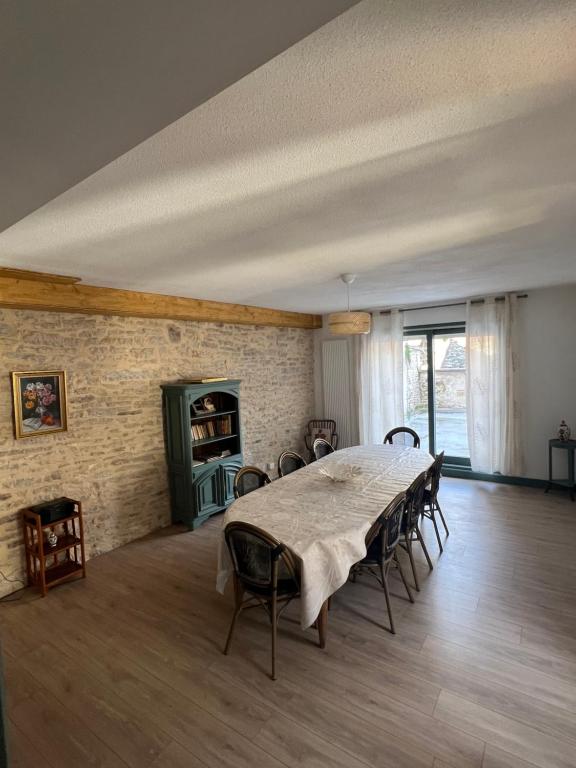 a large dining room with a table and chairs at G Opératif in Ornans