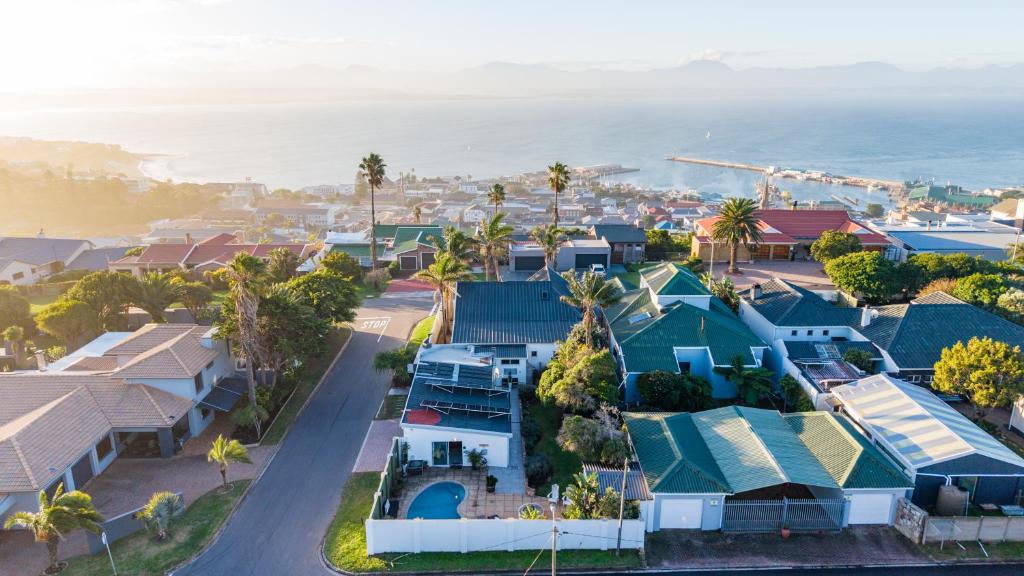 an aerial view of a coastal town with houses and the ocean at Villa Palmera in Mossel Bay