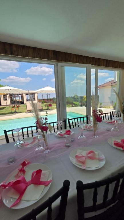 a table with a pink table cloth and glasses on it at Vino & Vista in Ripanj