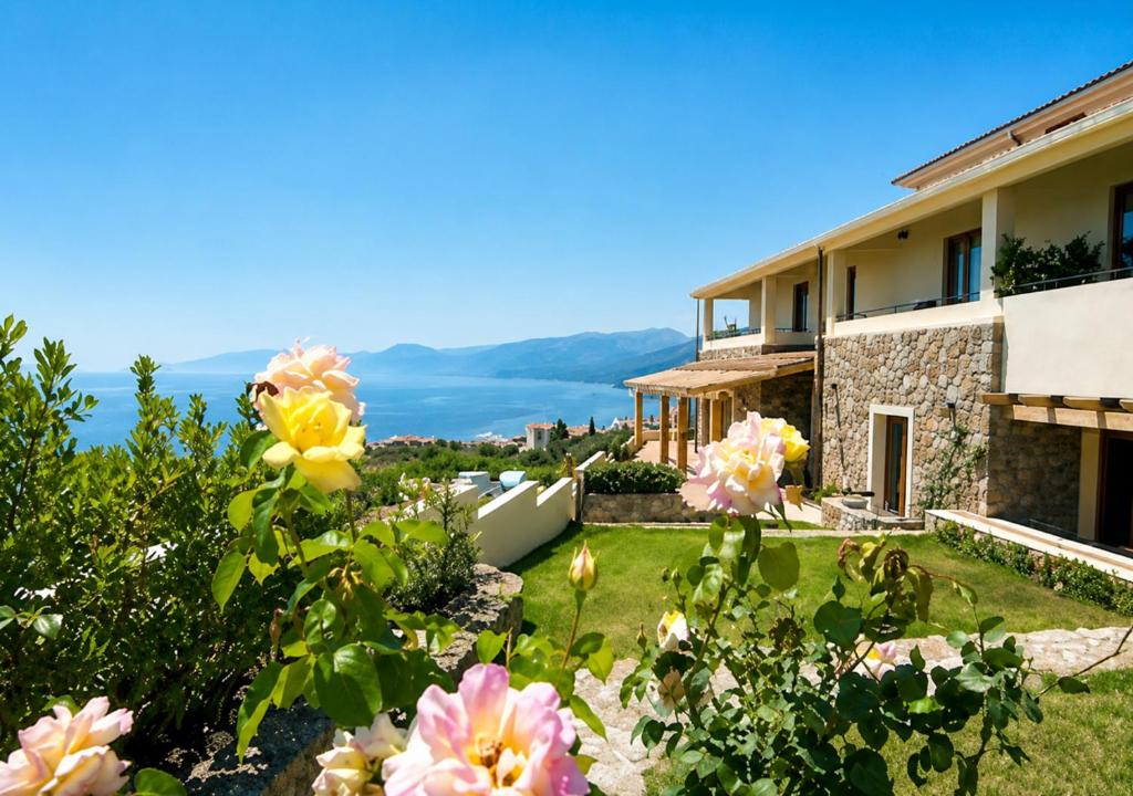 a view of a house with flowers in the yard at Hotel Villa Gustui Maris in Cala Gonone
