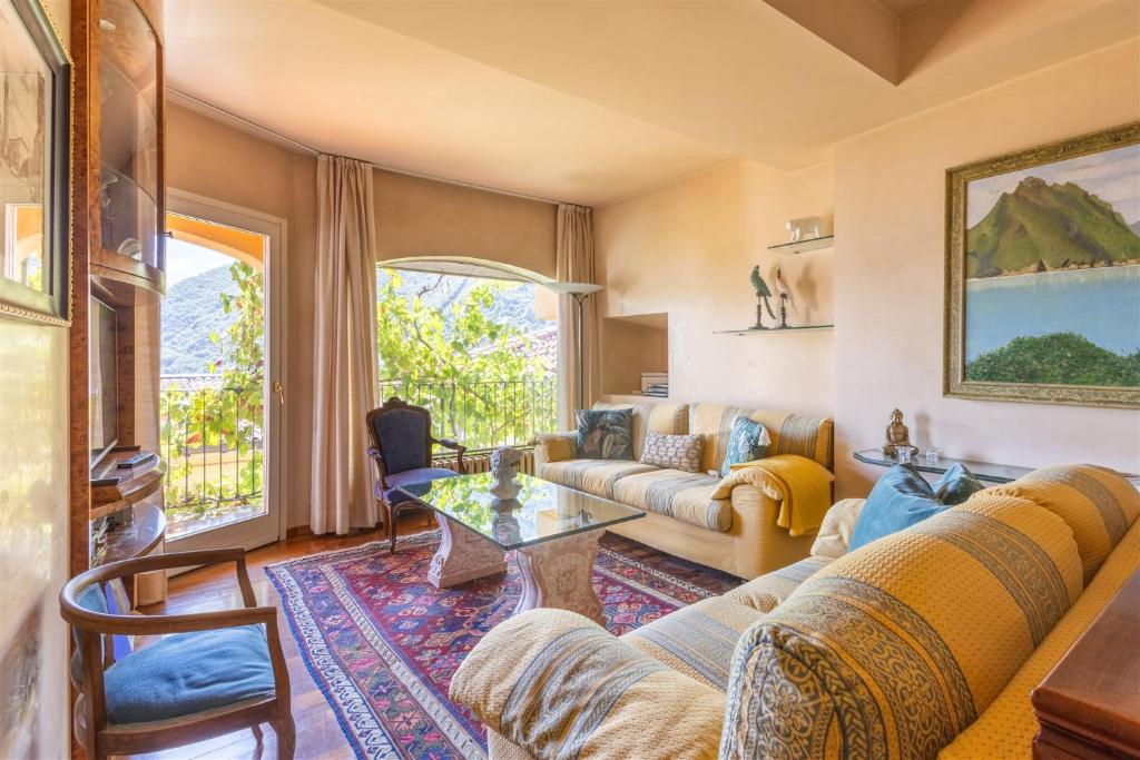 a living room with a couch and a table at IseoLakeRental - Nido Belvedere in Fonteno