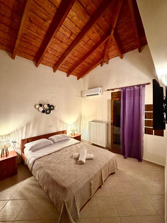 a bedroom with a large bed with purple curtains at Blue Horizon Makri in Alexandroupoli