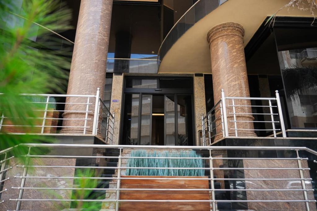 a staircase leading to a building with a fountain at Attawfeek Plaza in Tripoli