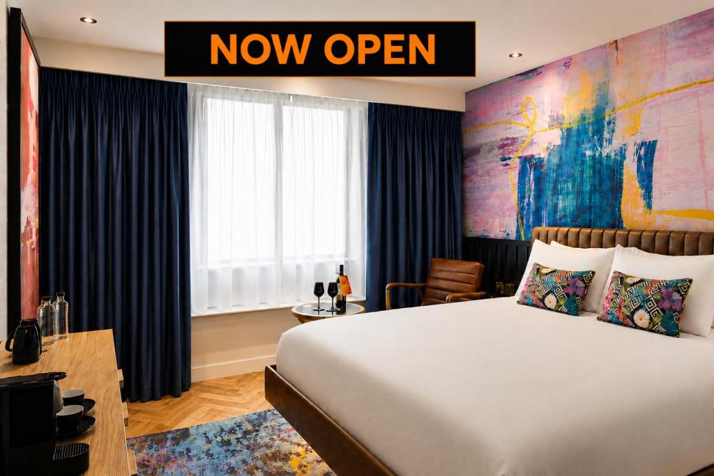 a hotel room with a bed and a now open sign at NYX Hotel Edinburgh in Edinburgh