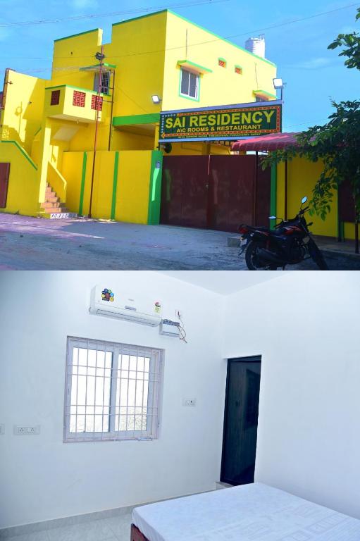a yellow building with a motorcycle parked in front of it at Sai Residency in Pallineriyanur