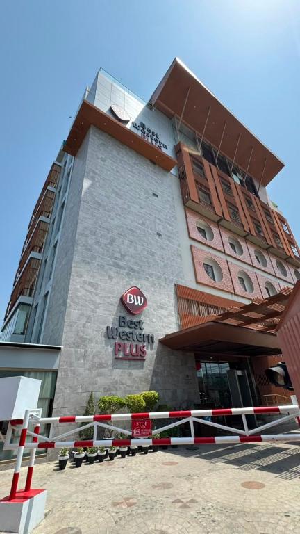 a building with a sign on the side of it at Best Western Plus Grand Multan in Multan