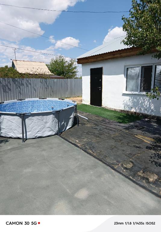 a trampoline in a driveway in front of a house at Сдается дача in Balqash