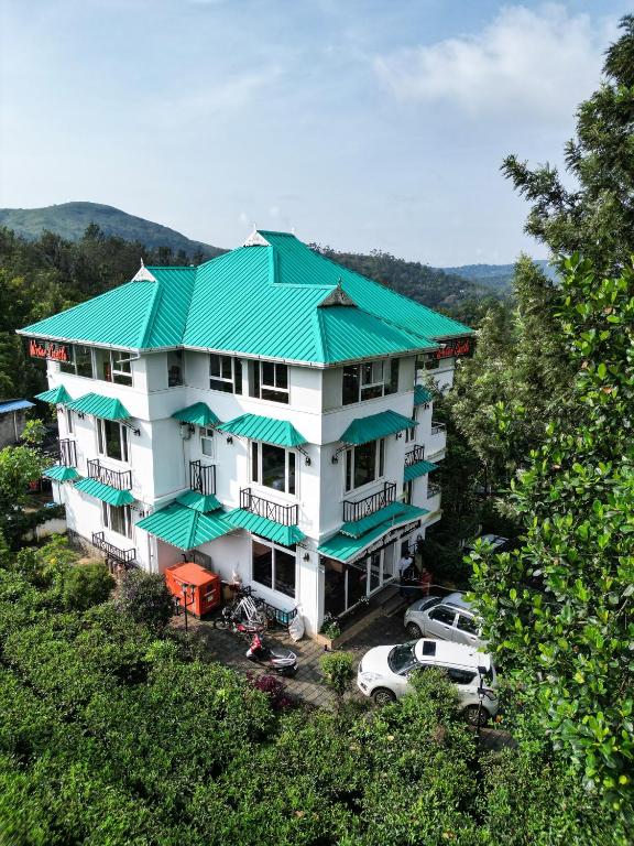 an overhead view of a building with a green roof at Lumino Winter Castle, Munnar in Pooppara