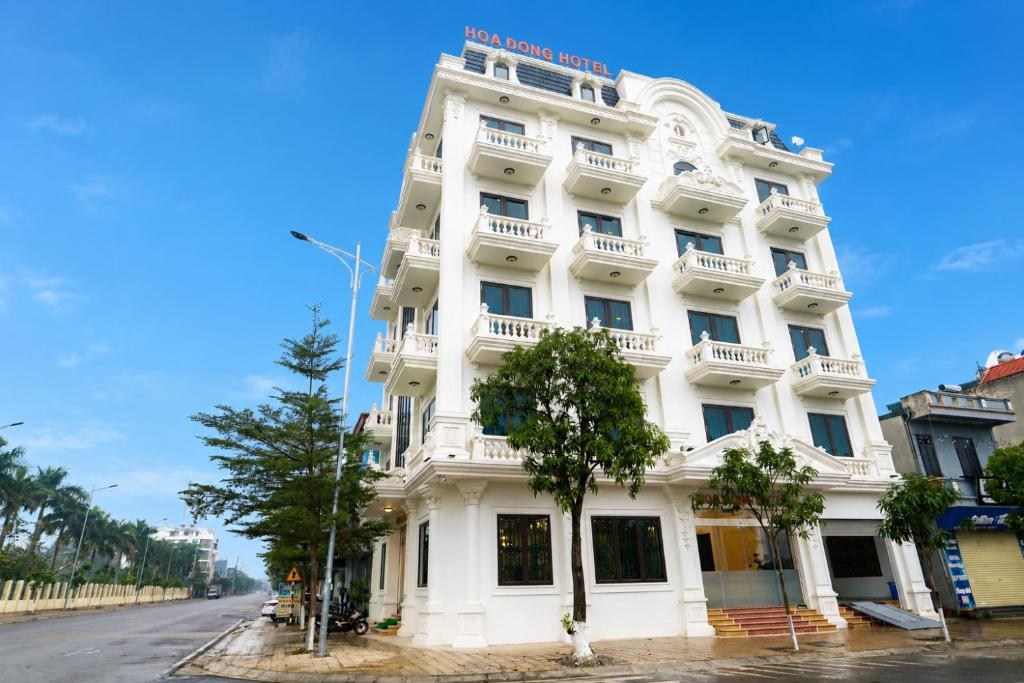 a white building on the side of a street at The Téa Opera Hotel - Hoa Đông Aureum in Châu Cầu