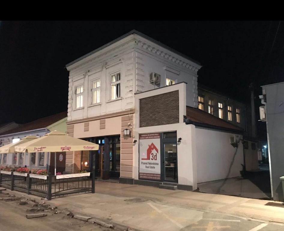 a white building with an umbrella in front of it at Tabacco in Obrenovac
