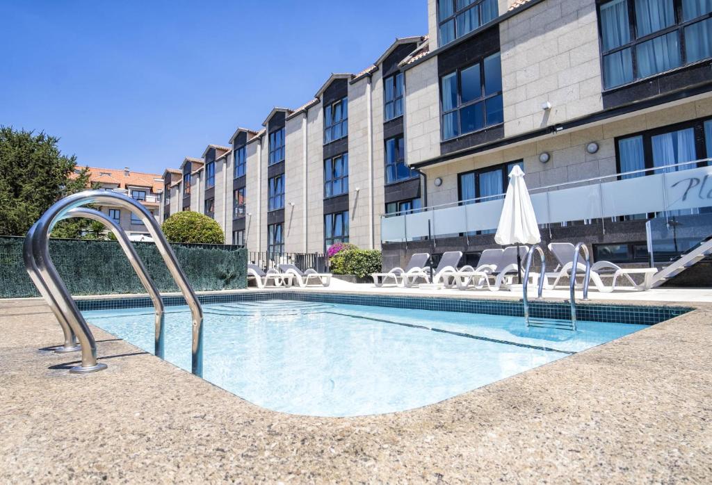 a swimming pool in front of a building at Alda Carril in Vilagarcia de Arousa