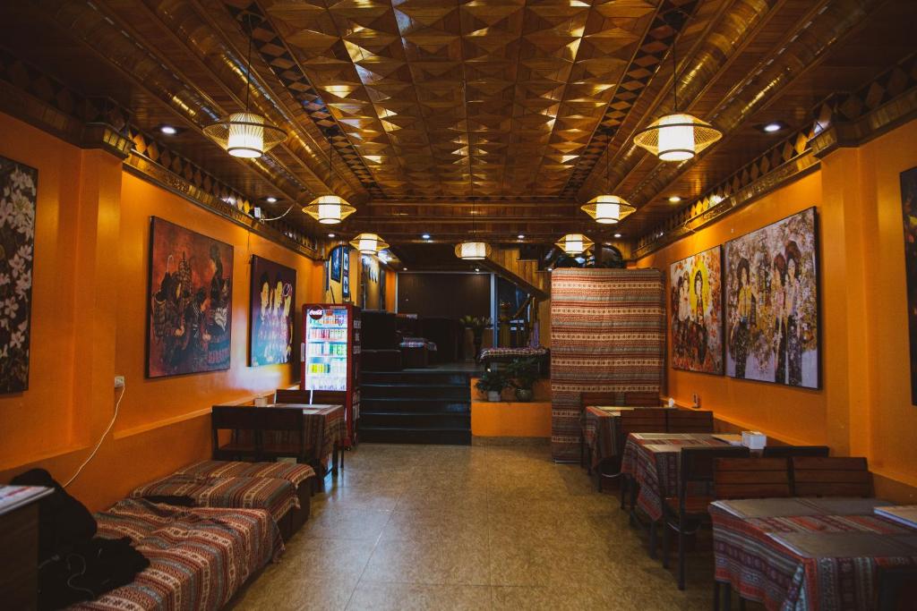 a restaurant with couches and tables in a room at Sapa Central House in Sapa