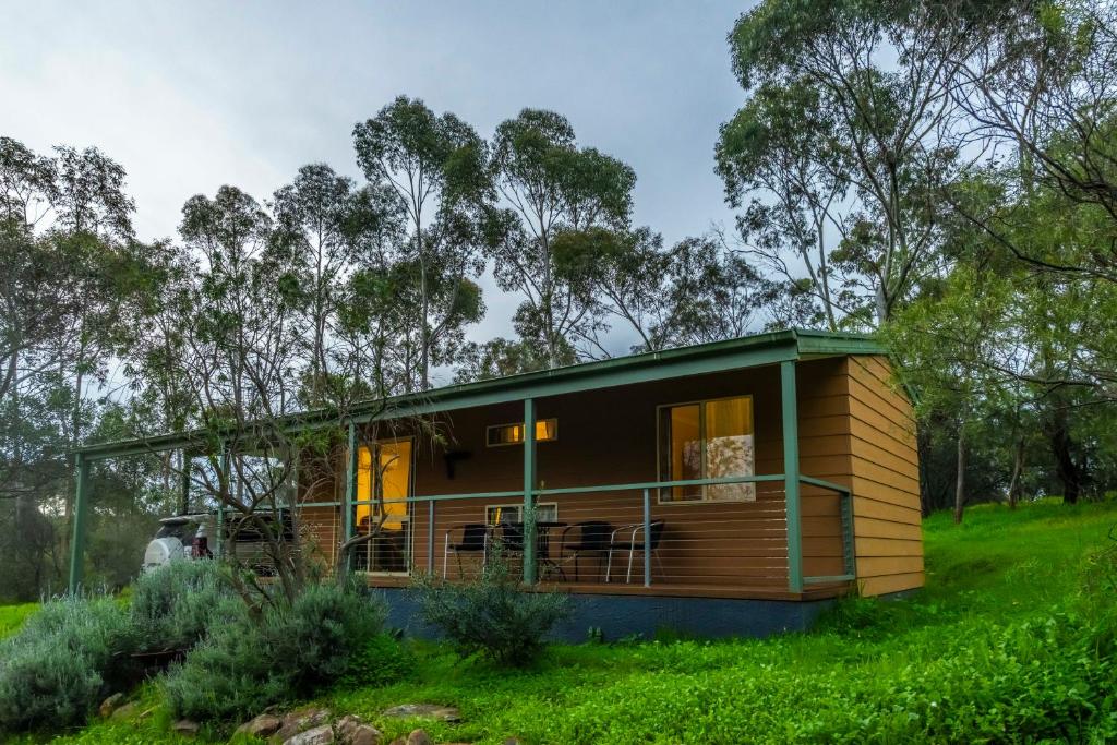 a tiny house on a hill with a green roof at Watervale Retreat in Watervale