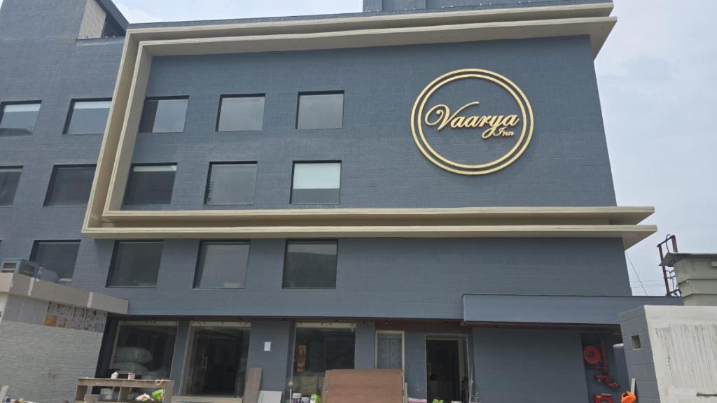 a building with a sign on the side of it at Hotel Vaarya Inn in Lucknow