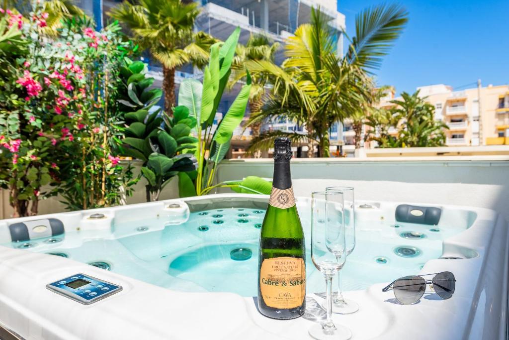 a bottle of champagne and glasses on a hot tub at Luxurious Two Bed in Torrox