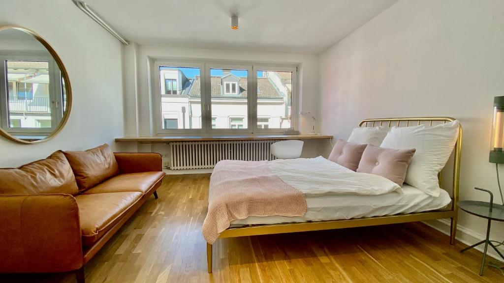 a living room with a bed and a couch at STACEY Alster in Hamburg